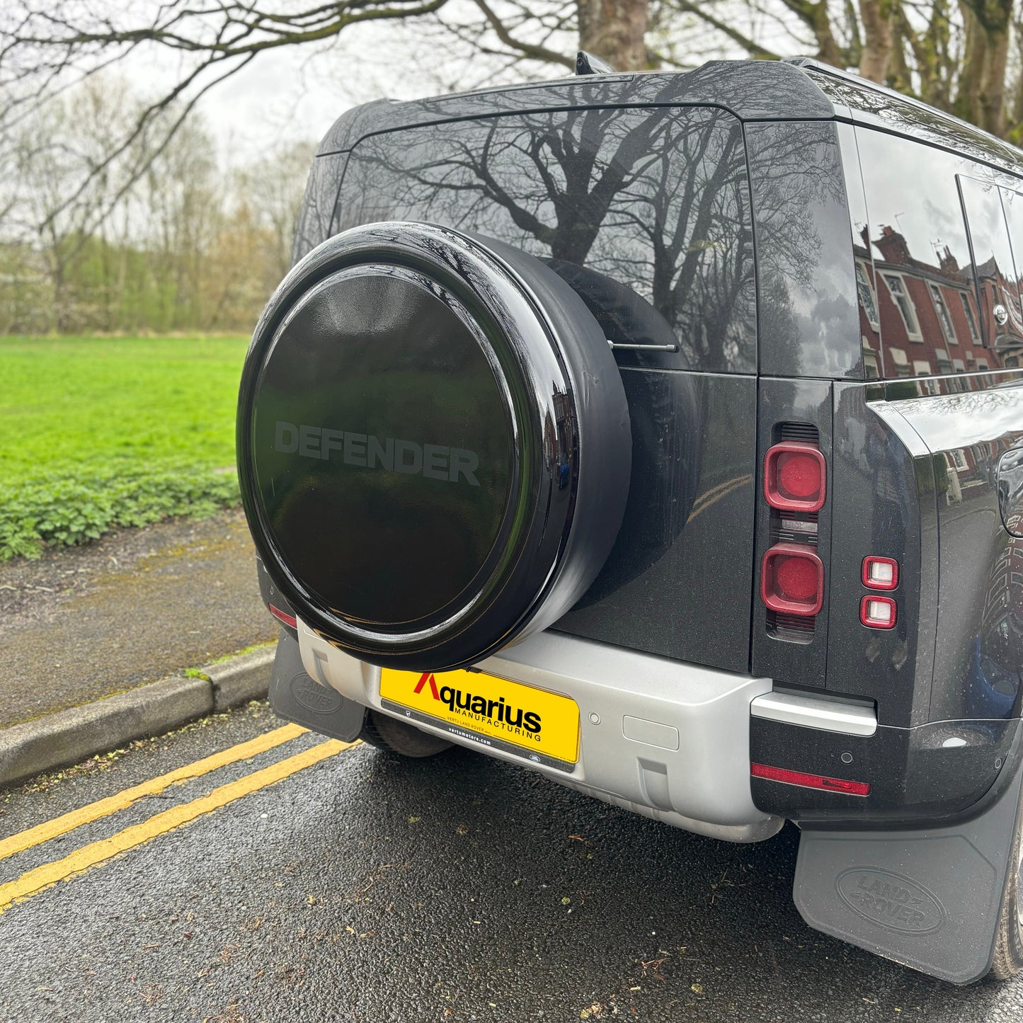 Black new shape land rover defender with black gloss Aquarius wheel cover with "DEFENDER" print